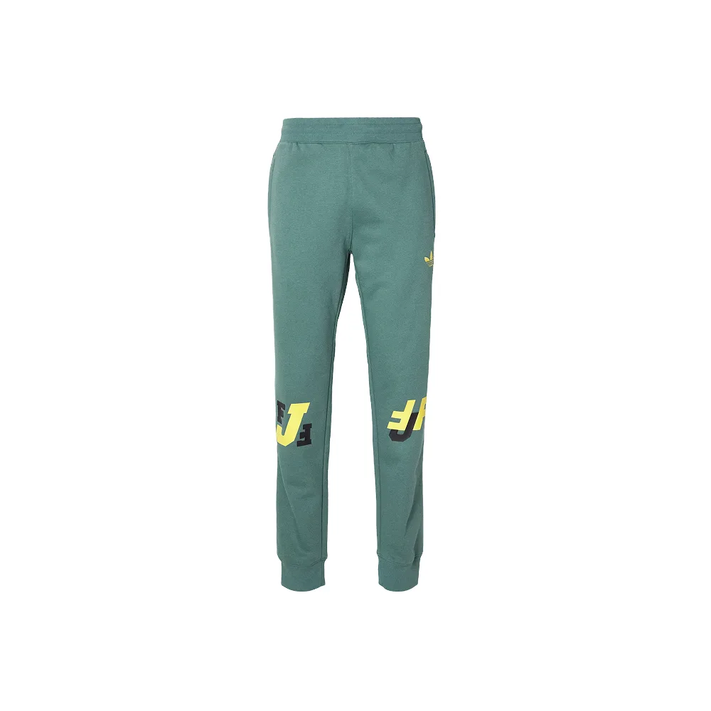 Adidas Originals Teceme trousers, фронтальный вид, мятный цвет с контрастными желтыми принтами